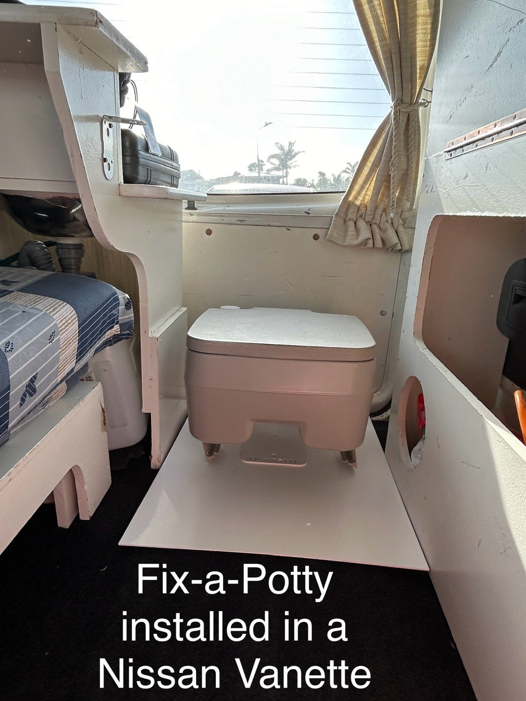 Portable toilet secured in campervan using Fix-a-Potty bracket