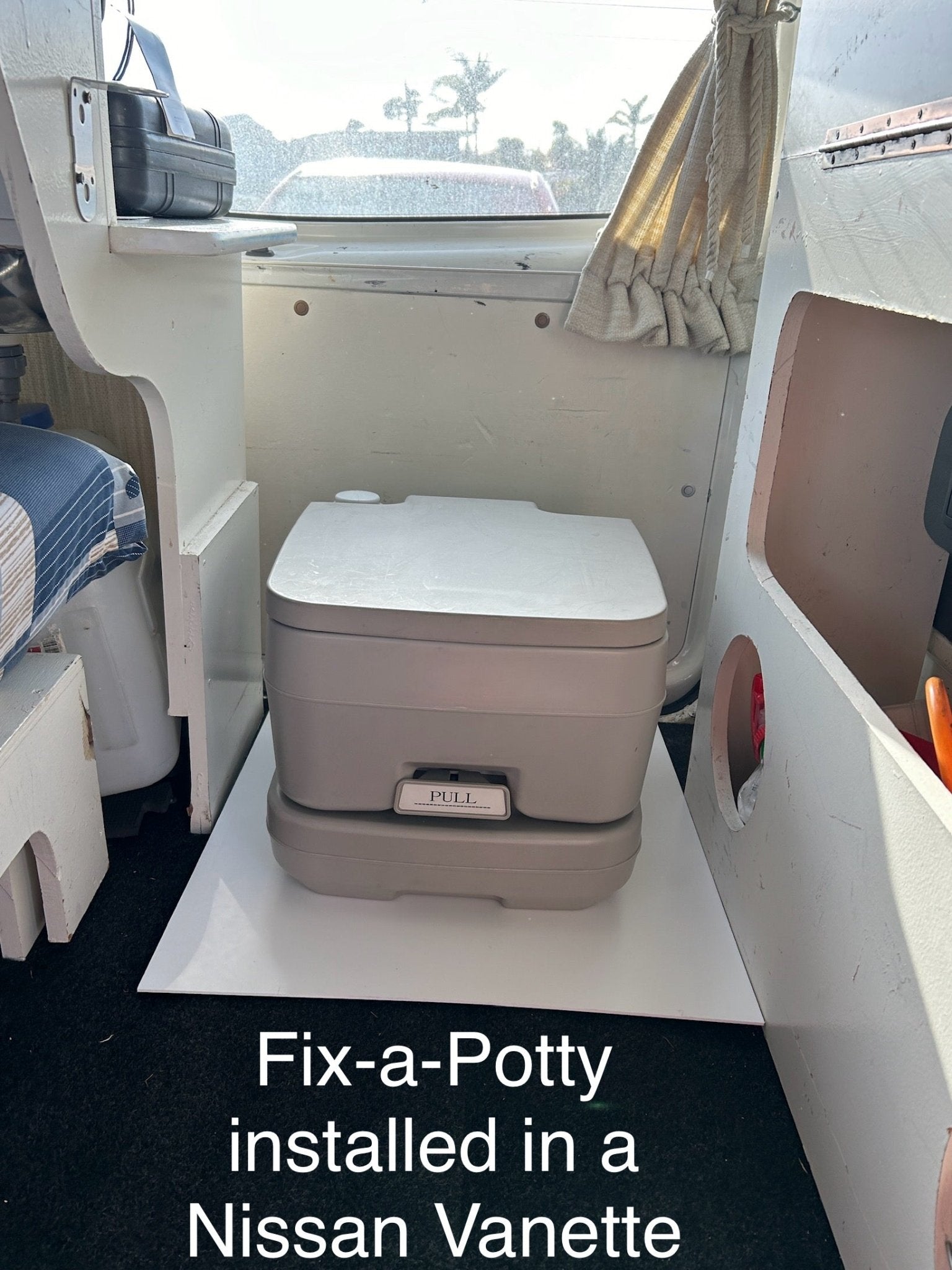 Fix-a-Potty 10L bracket securing a portable toilet in a campervan