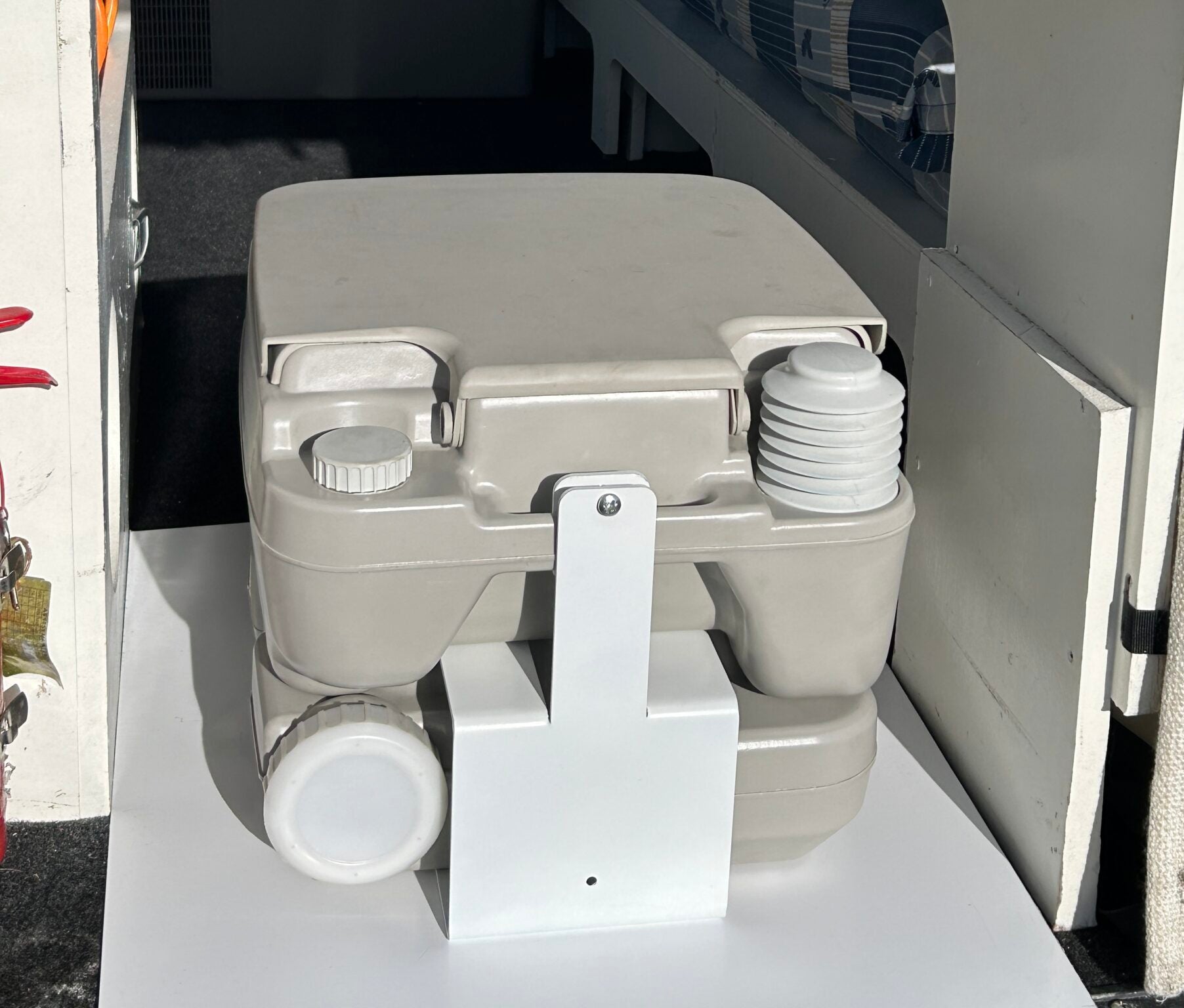 Campervan portable toilet held securely with Fix-a-Potty bracket